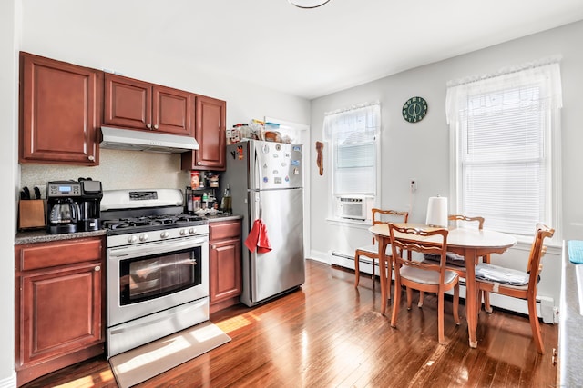 kitchen featuring a baseboard heating unit, hardwood / wood-style flooring, decorative backsplash, and appliances with stainless steel finishes