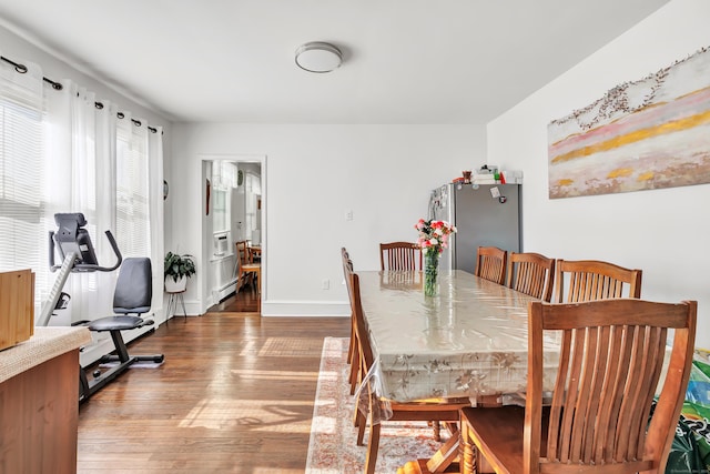 dining room featuring hardwood / wood-style floors and baseboard heating