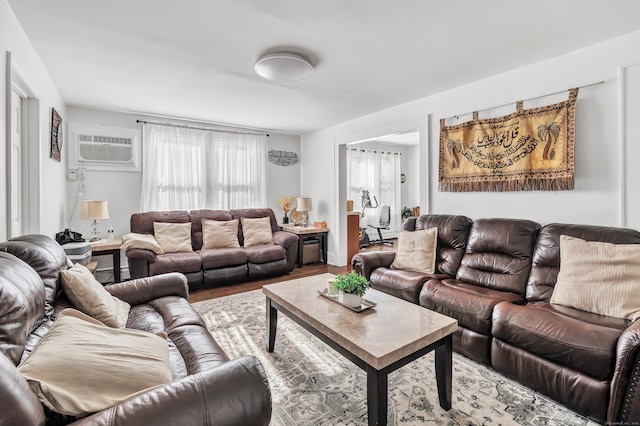 living room with hardwood / wood-style flooring, a baseboard heating unit, and a wall mounted air conditioner