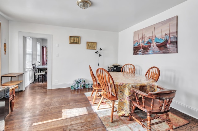 dining area with dark wood-type flooring