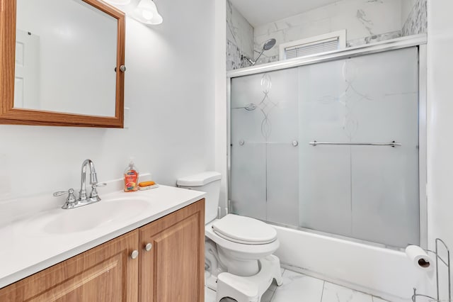 full bathroom featuring bath / shower combo with glass door, vanity, and toilet