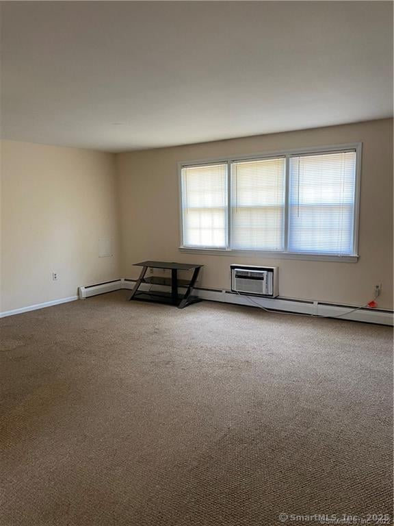 carpeted empty room with a wall unit AC