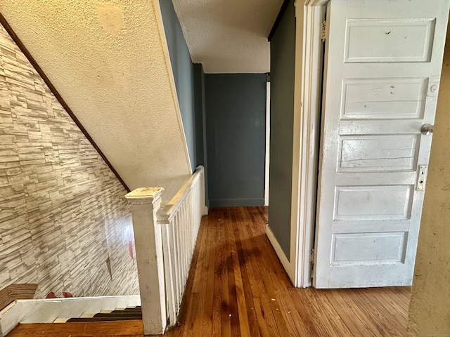 corridor with hardwood / wood-style floors