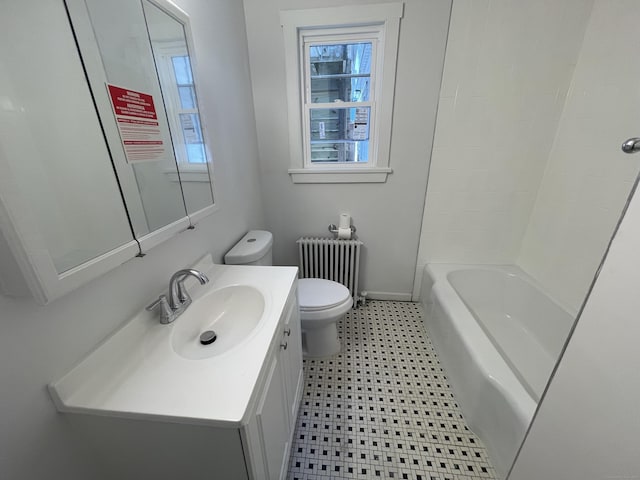 bathroom with vanity, radiator heating unit, toilet, and plenty of natural light