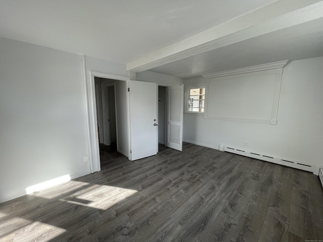 unfurnished room with dark hardwood / wood-style floors and baseboard heating