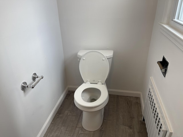 bathroom with toilet and hardwood / wood-style floors