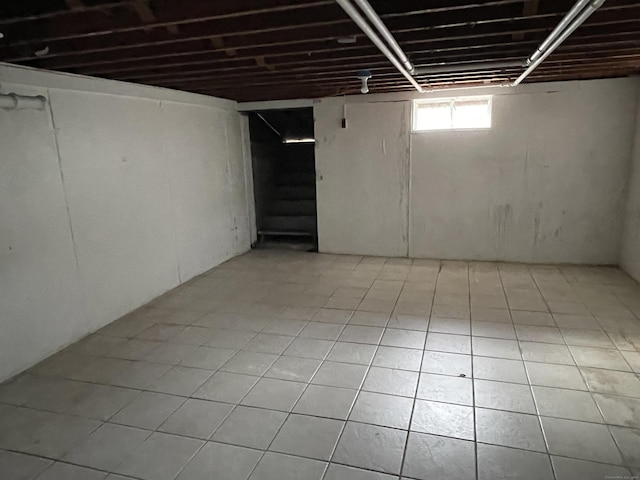 basement featuring light tile patterned floors