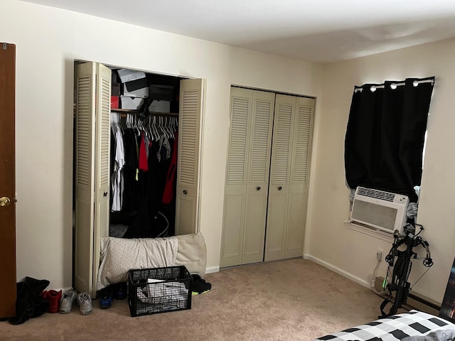 carpeted bedroom featuring multiple closets and cooling unit