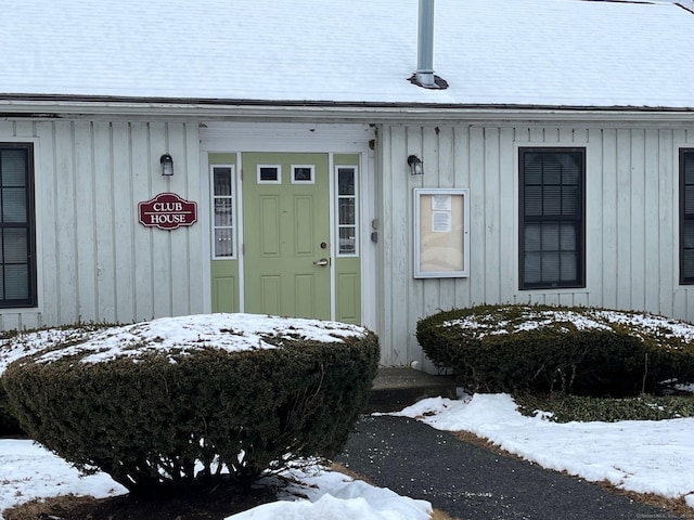 view of snow covered property entrance