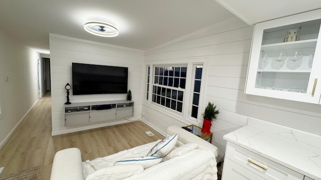 living room with lofted ceiling and light hardwood / wood-style flooring