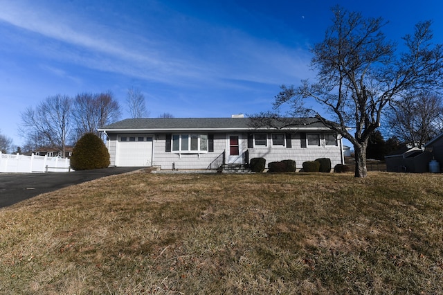 ranch-style house with a garage and a front lawn