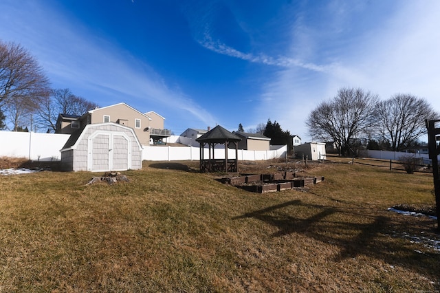 view of yard with a gazebo and a storage shed