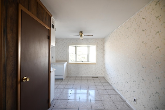 tiled empty room featuring ceiling fan