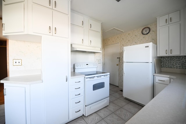 kitchen with white cabinetry, light tile patterned floors, and white appliances