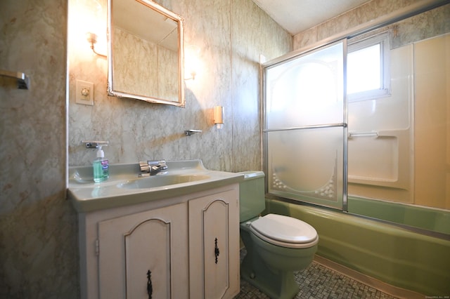 full bathroom featuring vanity, tile patterned flooring, toilet, and combined bath / shower with glass door