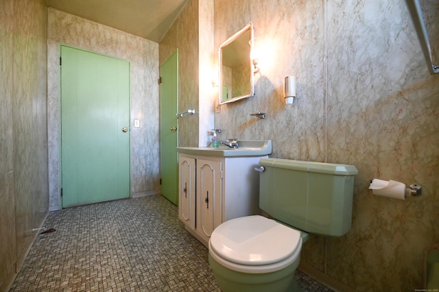 bathroom featuring tile patterned flooring, vanity, and toilet