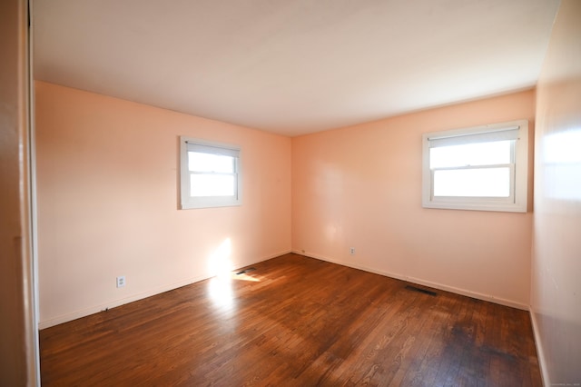 spare room featuring dark wood-type flooring