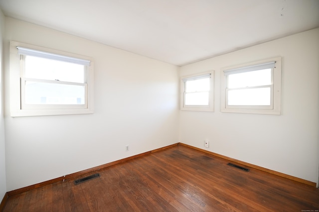 empty room with dark wood-type flooring