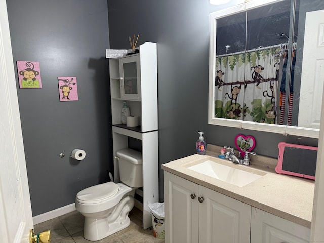 bathroom featuring vanity, a shower with shower curtain, tile patterned floors, and toilet