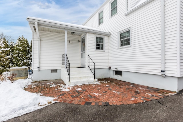 view of snow covered property entrance