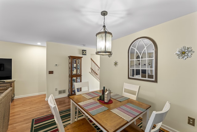 dining area with recessed lighting, visible vents, light wood-style flooring, baseboards, and stairs