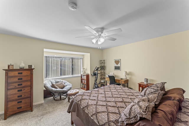 carpeted bedroom featuring baseboards and a ceiling fan