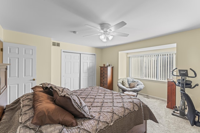 carpeted bedroom featuring ceiling fan, a closet, visible vents, and baseboards