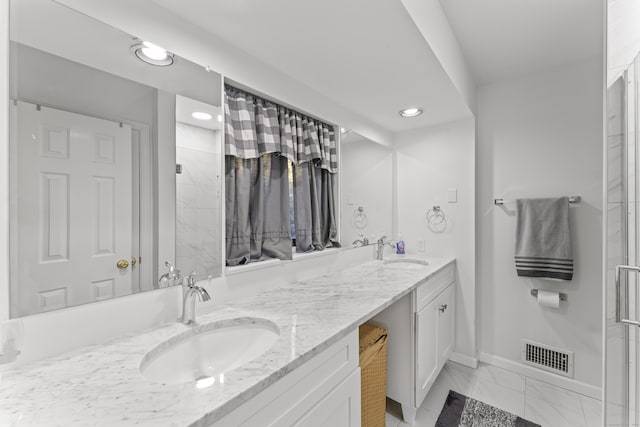 full bath featuring double vanity, marble finish floor, visible vents, and a sink