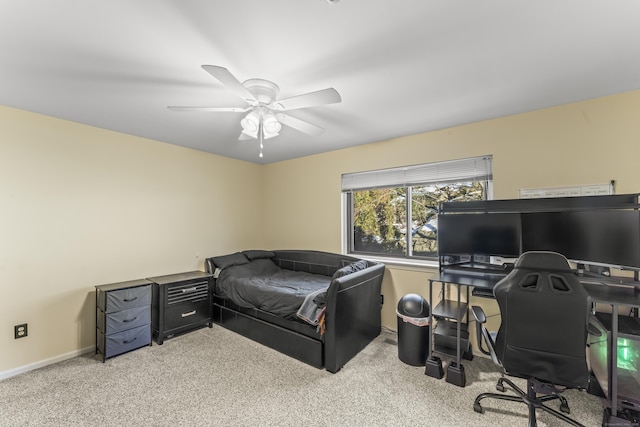 carpeted bedroom featuring baseboards and a ceiling fan