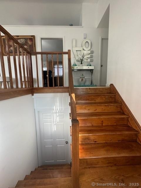 stairway with hardwood / wood-style floors