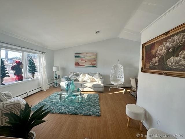 living room with baseboard heating, lofted ceiling, and hardwood / wood-style floors