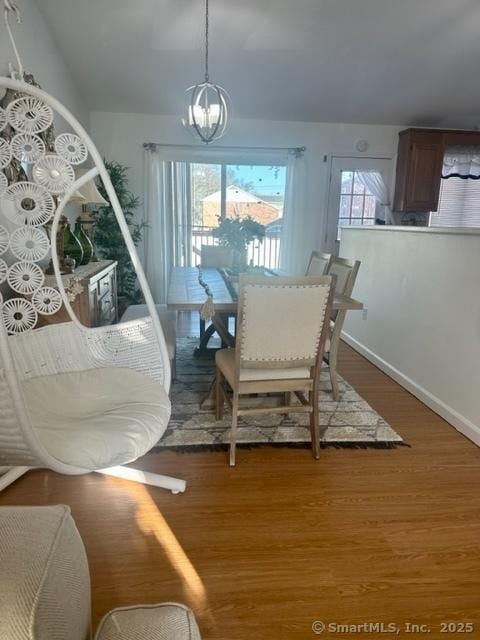 dining room featuring an inviting chandelier and wood-type flooring