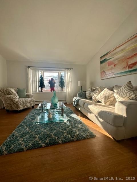 living room with lofted ceiling and hardwood / wood-style floors