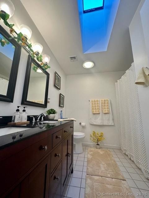 bathroom featuring vanity, tile patterned floors, and toilet