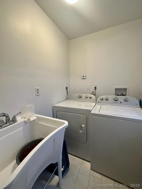 laundry area featuring independent washer and dryer and sink