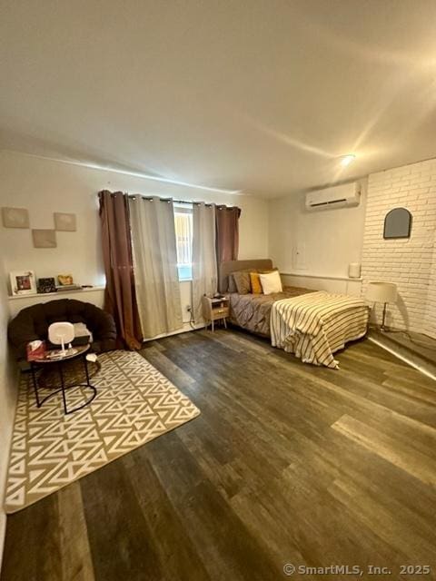 bedroom featuring wood-type flooring and a wall unit AC