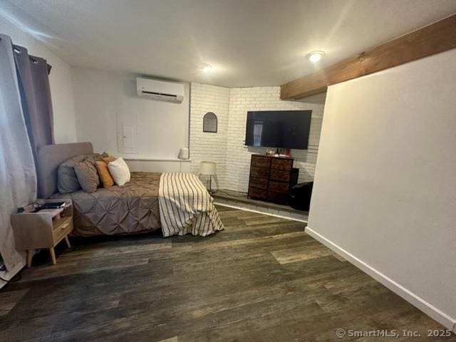 bedroom featuring dark hardwood / wood-style floors, a wall mounted AC, and beam ceiling