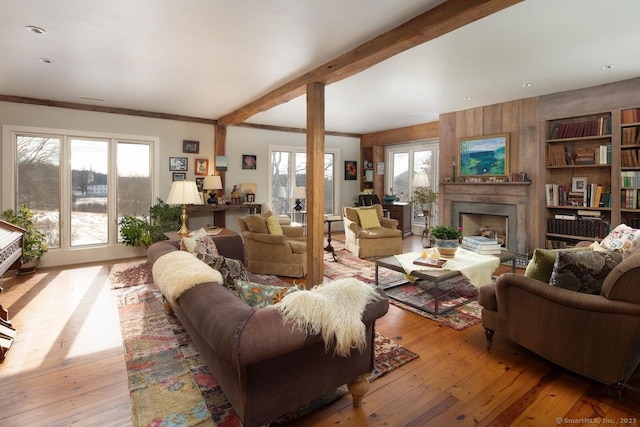 living room featuring beamed ceiling and light wood-type flooring