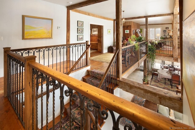 interior space with beamed ceiling and light hardwood / wood-style floors