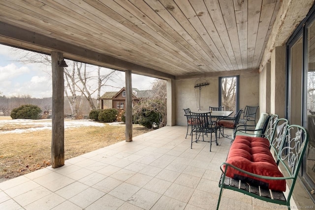 sunroom with wooden ceiling and a healthy amount of sunlight