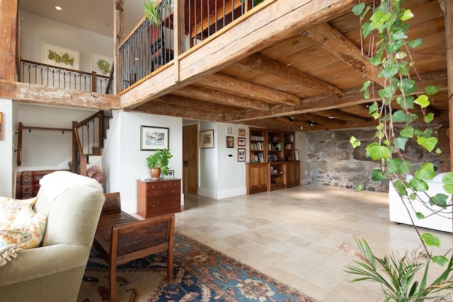 interior space featuring beam ceiling, wooden ceiling, and a towering ceiling