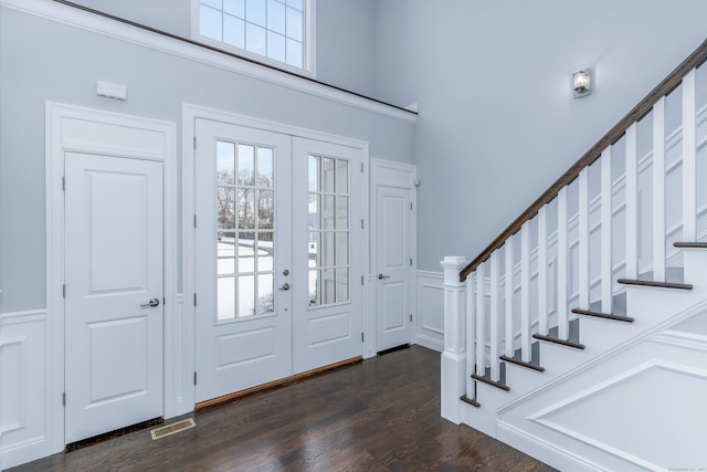 entryway with dark hardwood / wood-style flooring and french doors