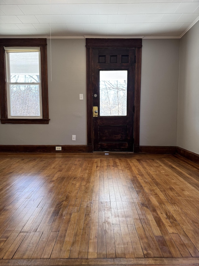 entryway with crown molding and hardwood / wood-style flooring