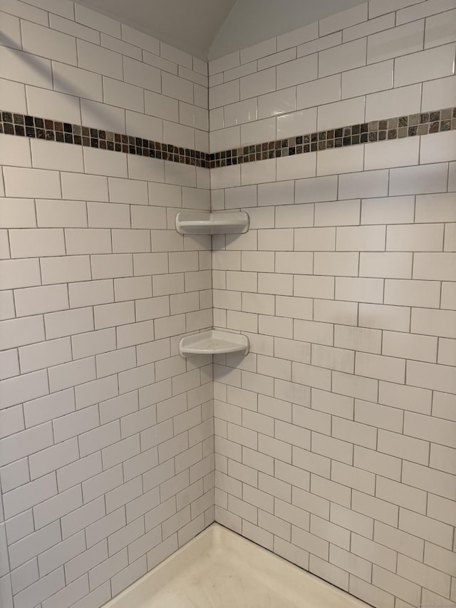 bathroom with a tile shower