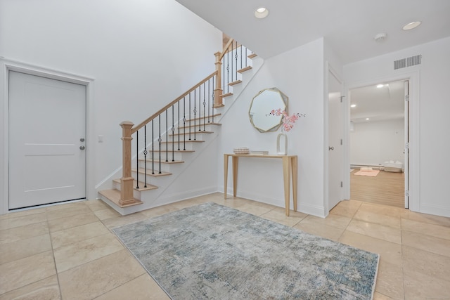 foyer entrance with stairs, light tile patterned flooring, visible vents, and recessed lighting