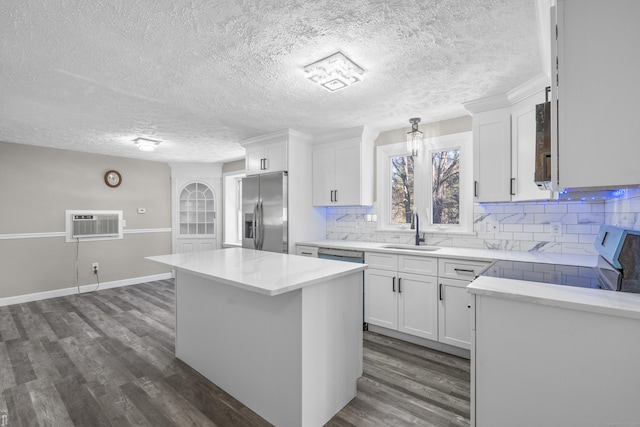 kitchen featuring sink, white cabinetry, stove, a kitchen island, and stainless steel fridge with ice dispenser