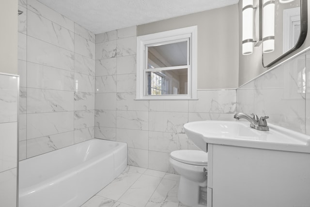 bathroom featuring vanity, toilet, a textured ceiling, and tile walls