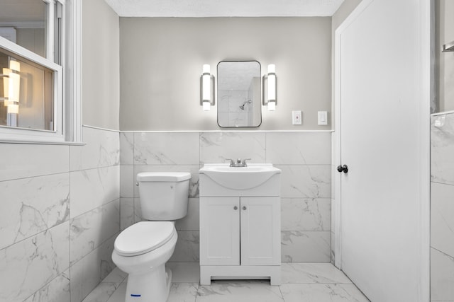 bathroom with vanity, a textured ceiling, and toilet