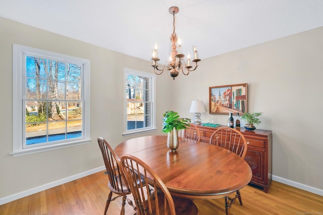 dining room with an inviting chandelier and light hardwood / wood-style floors