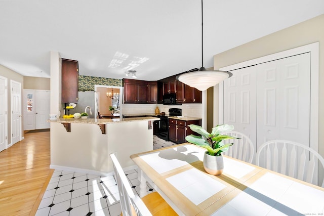 dining space with a chandelier and light hardwood / wood-style flooring